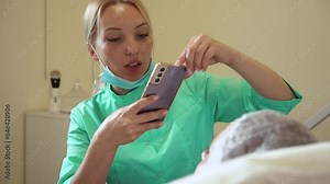 Doctor in medical gown taking photo on mobile phone before cosmetic procedure. Dermatologist performing non invasive procedure in beauty center