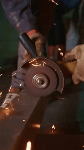 clip-4004093679-skilled-worker-operating-grinding-tool-shape-metal