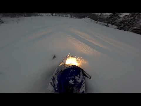 yamaha 200cc snowmobile riding in deep powder!