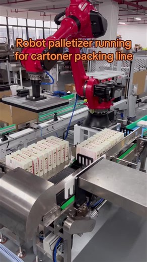 Robot palletizer running for cartoning packing line #robotarm #cartoningmachine