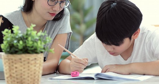 Asian Mom is Helping Her Son To Do Homework Stock Video - Video of holding, learning: 109915125
