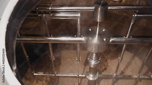 Inside the container, the ingredients for brewing beer are mixed. Operation of equipment at the brewery