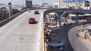 Car flies off overhead bridge in India and almost crushes bystanders