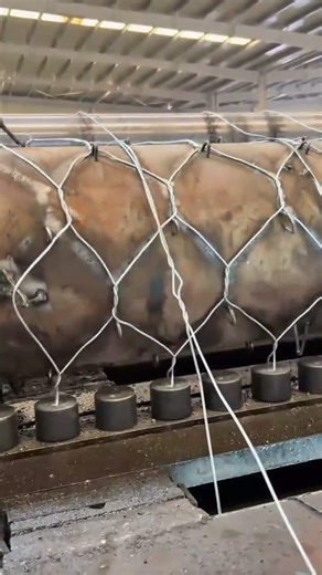 Weaving a Strong Metal Wire Mesh Around a Large Cylinder Using an Automated Industrial Machine