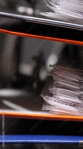 vertical video close-up binders are stacked. Archive of documents in a stack.