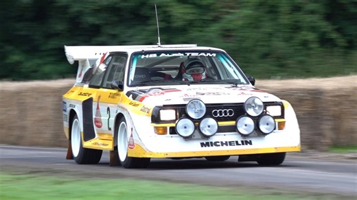 Audi Quattro rally car pushing hard on a narrow race road