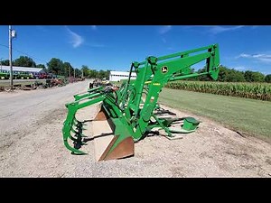 H480 SELF-LEVELING LOADER WITH GRAPPLE ATTACHMENT