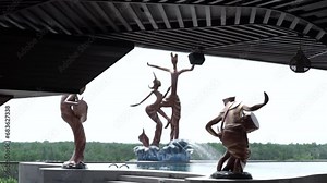 View of the swimming pool and surrounding statues. Replica of a traditional dancer statue