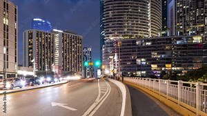 Night time lapse of traffic on a drawbridge over the Miami River and the tall buildings of Miami Florida