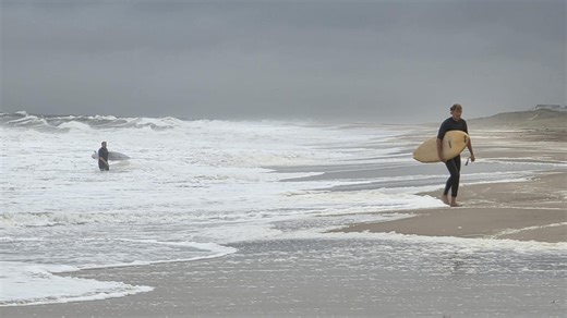 Surfers catch waves at Delaware Seashore State Park Aug. 18, 2025