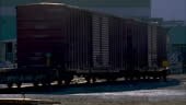 WIDE ANGLE OF FREIGHT TRAIN WITH ENGINEER OR CONDUCTOR AND HEADLIGHTS...