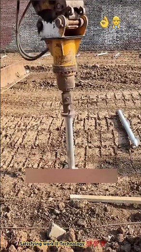 Construction excavator installing steel pile underground