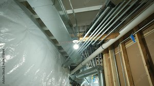 Mounted HVAC system air conditioner return and heating system in basement home. Move wide shot in basement