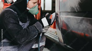polishing putty on the car body, body work restoration of paintwork