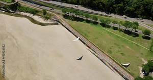 Top down aerial view of hang glider landing on the beach, Rio de Janeiro
