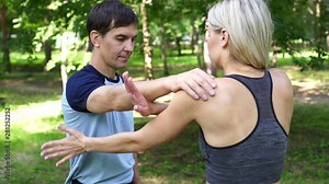 Young woman is engaged in fitness and wrestling in the park.