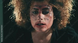 insanity, crisis - woman in a nervous breakdown looks at the camera and cries