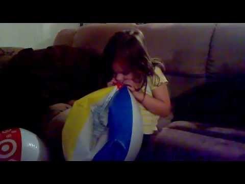 Autumn teaches how to blow up a beach ball