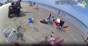 Video shots intoxicated couple woken at beach by cops looking for kids
