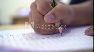 School / university Students hands taking exams, writing examination room with holding pencil on optical form answers paper sheet on desk doing final test in classroom. Education assessment Concept