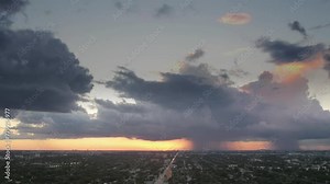 Timelapse shot. A very large storm cloud looms in the sky showcasing dramatic rolling storm clouds and flashes of lightning Dramatic rolling storm clouds with flashes of lightning