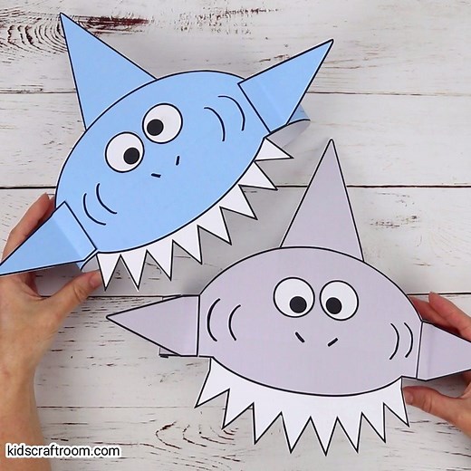 These shark hats are so cool! The printable template comes in 3 fun colours and B/W. It's the perfect shark craft for Summer and Shark Week! See the full details and get your printable here: https://kidscraftroom.com/shark-hat-craft/ | Kids Craft Room