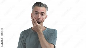 Middle-aged frustrated man with grey hair and bristle, making facepalm and looking bothered, standing upset over white background