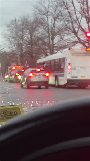 School Buses Holding Traffic with Lights On at School — Necessary