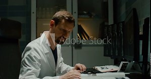 The radiologist examines the MRI images on the computer.
