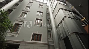 Glass atrium roof inside a building - business center, hotel or shopping mall. gray tones, concrete.