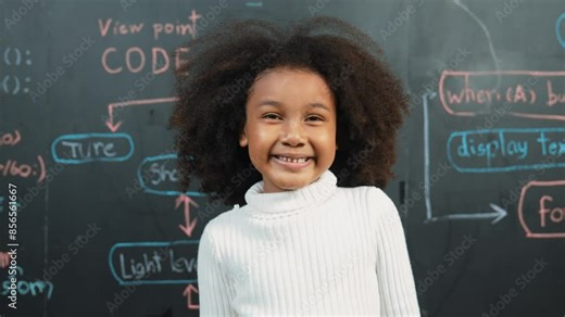 Happy african student smiling and standing at board with engineering prompt or coding, programing system written in STEM technology classroom. Child present science theory or innovative. Erudition.