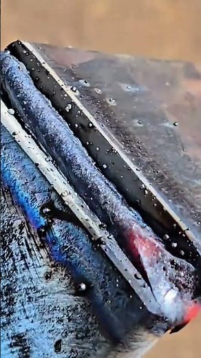 Intense welding sparks exploding brightly during metal fusion process