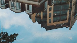 Building reflection on the rain puddle. Reflections in the rain water on the street