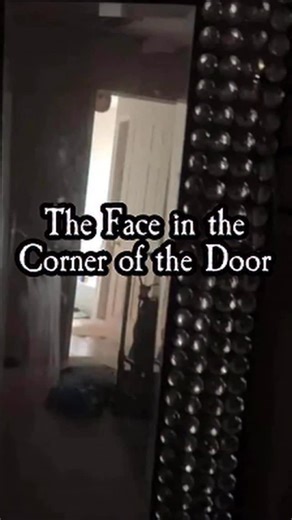 The Scarecast on Instagram: "A redditor was casually filming in their mom’s room when a friend suddenly noticed something peeking from the top corner of the doorway in the mirror’s reflection. In the screenshots, a pale face appears near the top of the doorframe, angled down as if someone were hanging from the ceiling and leaning into the room. The poster also reported ongoing activity in the house—doors closing on their own, screams around 3AM, and shadowy movement by the kitchen—adding to the 