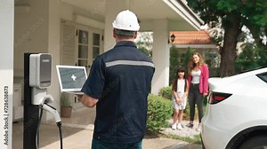 Qualified technician working on home EV charging station installation, making troubleshooting and configuration setup on charging system with laptop for EV at home. Fastidious