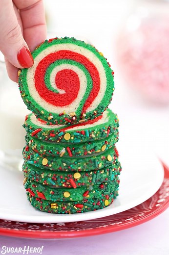Festive Pinwheel Sugar Cookies are beautiful AND delicious! 💚💖 They’re made with a simple sugar cookie dough, rolled into a beautiful red, white, and green spiral design, and rolled in sprinkles. ✨ WHAT YOU’LL NEED: • 12.75 oz all-purpose flour, (3 cups) • 1 tsp baking powder • ½ tsp salt • 8 oz unsalted butter, (1 cup), at room temperature • 8.75 oz granulated sugar, (1.25 cups) • 1 large egg, at room temperature • 2 tsp vanilla extract • Red and green food coloring, I used Americolor gel col