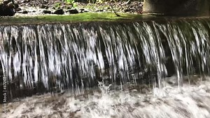 River water flows through the hallway and falls down, 4k footage of river flow, footage for advertising and films, beautiful footage of flowing water