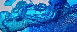 Blue liquid floating. Glitter fluid abstract background. Ink water. Sea wave. Blue color shimmering glowing grain dust mist texture liquid paint splash motion. 4k video