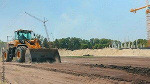 Modern tractor on a construction site. Large yellow tractor. Professional construction equipment. Work process at a construction site Stock Video