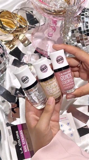 Official L.A. COLORS Cosmetics on Instagram: "Get ready to ring in the New Year with a quick dry mani that shines 🪩✨ Quick Color makes last minute New Year’s Eve nails easy with a fast drying formula and a glossy, party ready finish. Perfect for layered looks that still get you out the door on time. Start with Pure Love as your base, layer on Inspire for shimmer, add GemLike stickers for that extra sparkle, and seal it all in with Clarity for a smooth, long lasting shine that lasts past midnigh