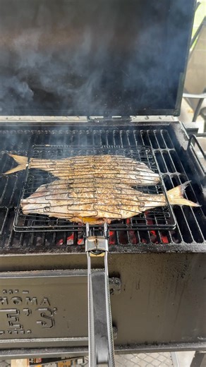 Whole grilled scup coming in HOT for game day 🏈🔥 @paulie_sauce with the perfect recipe. Crispy skin, lemon, oregano. The perfect seafood play. Who’s hungry? 🍋🐟 Full Recipe ⬇️ https://bit.ly/4gjfefk #GameDayEats #GrilledScup #TailgateBBQ #oklahomajoes | Oklahoma Joe's Smokers