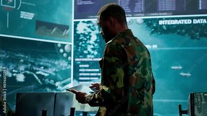 Cybersecurity specialist operates in a high tech military control center, monitoring surveillance footage and gathering intelligence for a new defense mission. Secret service activity. Camera A.