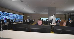 Security guards monitoring modern CCTV cameras in surveillance room