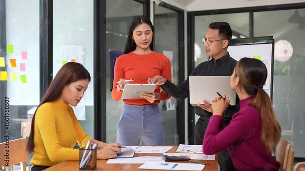 Efficient teamwork and collaboration among professionals in modern office lead to creative discussions and impactful presentations that drive business success.