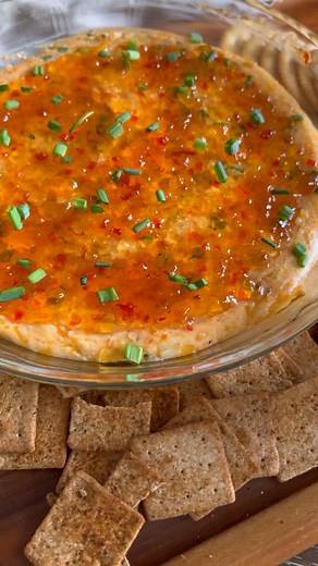 Pepper Jelly Cheese Dip! 🌶️ The perfect easy party appetizer. Ingredients: • 1 block (8 oz) cream cheese, room temperature • 4 oz shredded sharp cheddar cheese • 4 oz shredded pepper jack cheese • 1/4 cup chopped green onions • 1 tsp Britscookin Cajun seasoning (or your favorite seasoning) • 10oz red pepper jelly (divided) Instructions: 1. Preheat your oven to 350°F. 2. In a mixing bowl, combine cream cheese, sharp cheddar, pepper jack, green onions, Cajun seasoning, and 2 tbsp red pepper jelly
