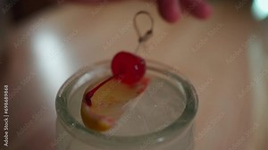 bartender prepare kamikaze cocktail in tiki glass with vodka, triple sec, lemon