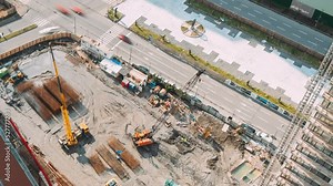 Construction cranes and excavators machinery working in development on construction site. hyperlapse timelapse time lapse Construction And Development Business. Elevated View construction site area