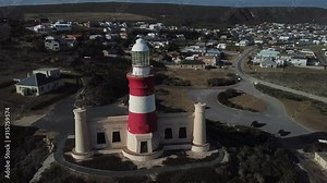 4K sunny summer aerial drone video of Cape Agulhas Lighthouse on southernmost tip of African continent peninsula near Indian Ocean coastal village L'Agulhas, Garden Route, Western Cape, South Africa