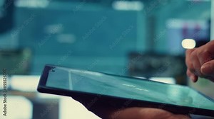 Navy operations specialist following hostile warship trajectory around the national waters, working on ensuring protection via satellite radar system on a tablet. IT professional. Close up. Camera B.