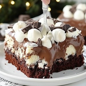 Hot Chocolate Poke Cake Ingredients: For the Cake: 1 box chocolate cake mix (plus ingredients listed on the box: usually eggs, oil, and water) 1 cup milk 1 package (3.9 oz) instant chocolate pudding mix For the Filling & Topping: 1 ½ cups hot fudge sauce or chocolate syrup 1 container (8 oz) whipped topping, thawed Mini marshmallows Chocolate shavings or cocoa powder, for garnish Instructions: 1. Bake the Cake: Preheat oven according to cake mix instructions. Prepare the cake batter as directed 